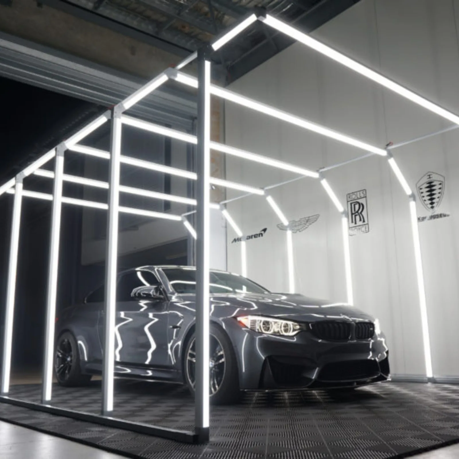 Dark sedan under workshop lighting after ceramic coating